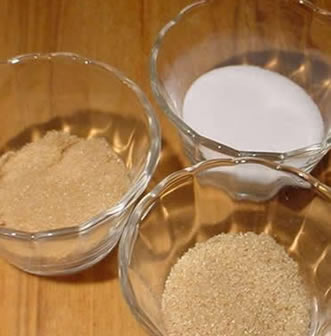 Photograph of three different types of industrial sugar